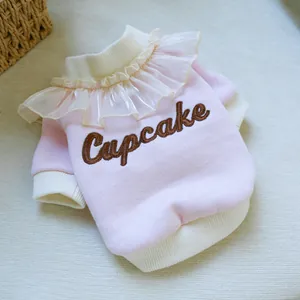 Detailed view of pink pet sweatshirt with cupcake embroidery and ruffled collar lace