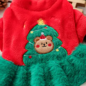 Detail of plush Christmas pet dress featuring festive bear and tree embroidery