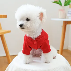 Close-up of a festive red pet cardigan featuring thick woolen fabric and button details