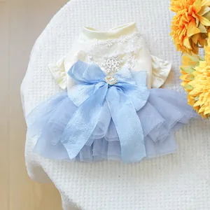 Detail of pet princess dress with blue mesh skirt, lace collar, and sequined snowflake