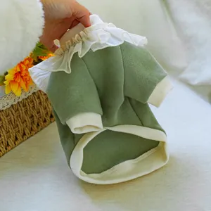 Detail of pet sweatshirt featuring white ruffled collar and ribbed green knit fabric