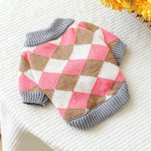 Detail of pink and brown argyle knit pet sweater with ribbed cuffs and soft plush texture