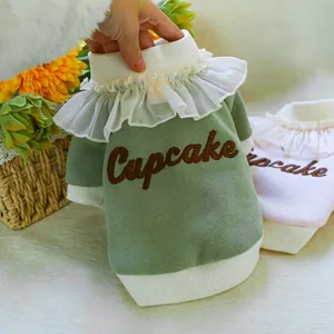 Detail of dog sweater with lace ruffle collar and cupcake embroidery on ribbed fabric