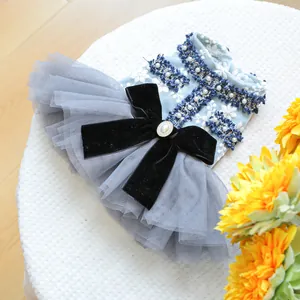 Detail of blue pet dress featuring velvet bow, pearls, and layered gray mesh skirt