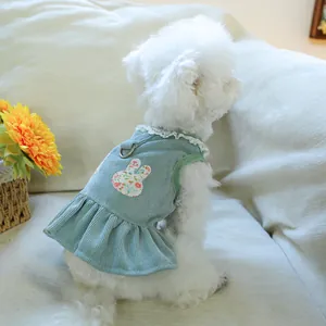 Light blue corduroy pet dress with lace collar and floral bunny patch on white small dog