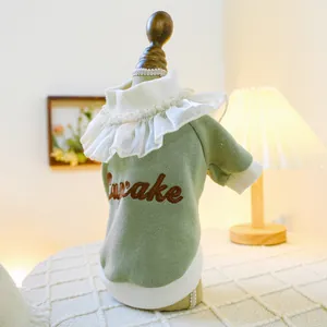 Detail of light green knit pet sweater with ruffled collar and Awake embroidery