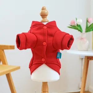Detail of red festive pet jacket featuring wool-like texture and bright red buttons