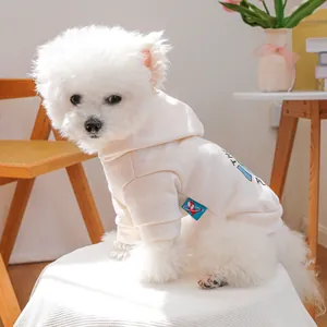 Detail of a creamy white pet hoodie featuring a cartoon earth print and soft ribbed cuffs