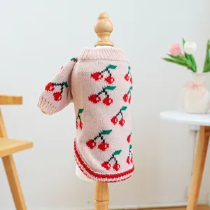 Detailed view of dog knit sweater featuring cherry patterns and ribbed edges on a mannequin