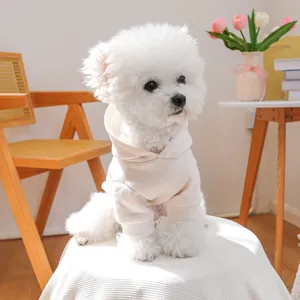 Close-up of white pet hoodie with soft fabric texture and ribbed cuffs on a small dog