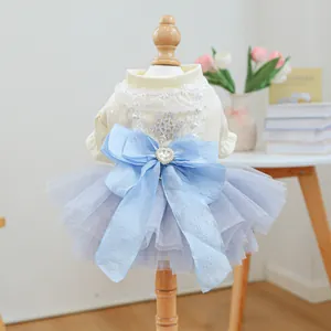 Close-up of pet dress showing lace top, blue bow with rhinestone and snowflake detail