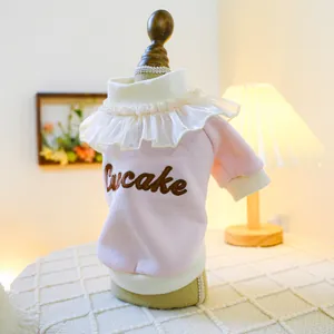 Close-up of pink pet sweater with ruffle lace collar and Cupcake embroidery detail