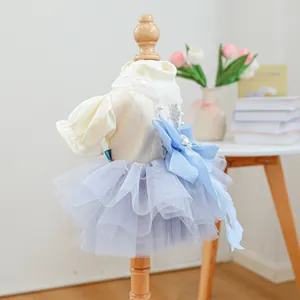 Close-up of pet princess dress featuring sequin bodice, lace collar, and large blue bow