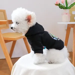 Detail of a black pet hoodie featuring a globe print and ribbed cuffs on a white dog