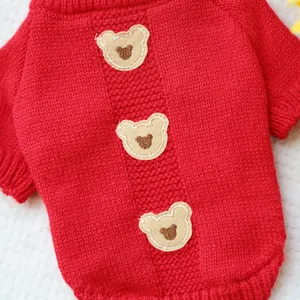 Detail of red knit pet sweater with three cute bear patches and heart embroidery