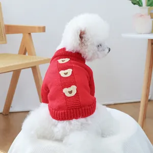 Detail of red knit pet sweater with cute brown teddy bear patches for small dogs