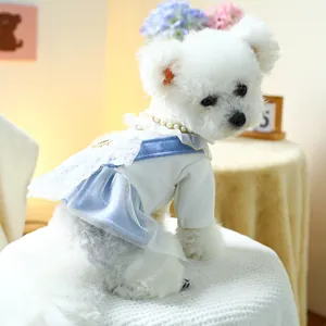 Detail of pet dress with blue lace straps, white mesh bow and pearl collar decoration