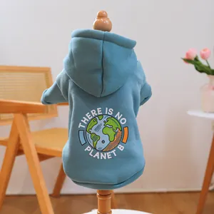 Blue pet hoodie with No Planet B print on a wooden model in a cozy room setting