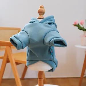 Detail of blue pet hoodie with hood on model, soft cotton fabric for small dogs