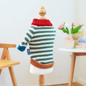Close-up of a striped pet sweater with red high neck and blue cuffs on a white mannequin