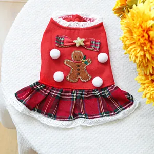 Detail of Christmas pet dress featuring gingerbread man patch and red plaid pleated skirt