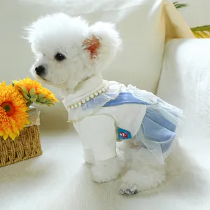 Detail of dog dress with pearl collar and light blue lace mesh on soft knit fabric