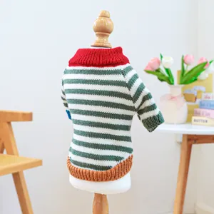 Detailed view of colorful retro striped pet sweater with festive knit texture on a model