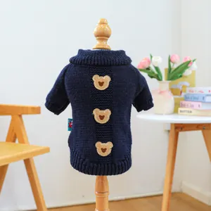 Detail of cable knit pet sweater in navy blue with three cute bear patches on a mannequin