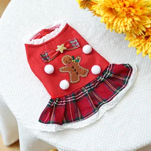 Christmas dog dress with gingerbread embroidery and red plaid skirt on white background