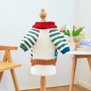 Close-up of retro striped pet sweater with colorful ribbed knit details and side label