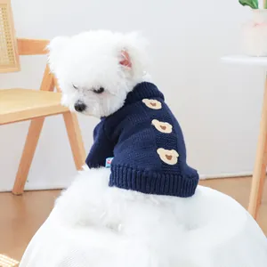Detail of navy blue pet knit sweater featuring cute beige cartoon bear patches and high neck
