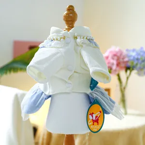 Detailed view of dog cardigan with pearl collar, gold trim, and blue tulle ruffles