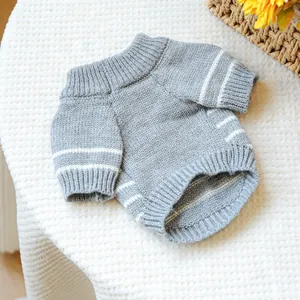 Detail of grey knitted pet sweater showing thick texture and white stripe accents