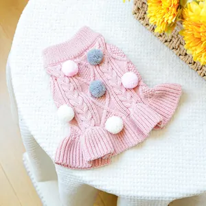 Pink knit pet sweater with cable pattern and pom-pom details for small dogs and cats
