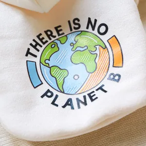 Detail of cream dog sweatshirt featuring earth illustration and There Is No Planet B slogan