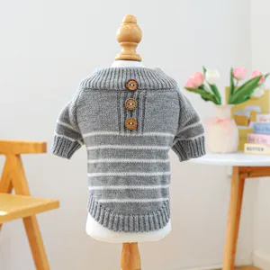Close-up of grey and white striped pet sweater with knitted texture and wooden buttons
