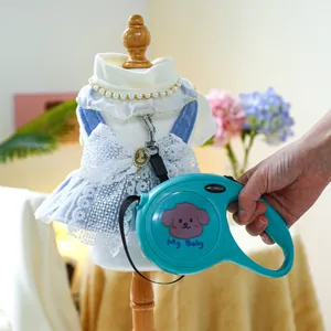 Close-up of a blue pet dress with lace details and matching retractable leash on a mannequin