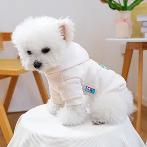 Detail of soft cream pet hoodie with green dinosaur print on a small dog model