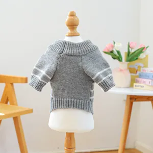 Detailed shot of grey knit pet sweater with white stripes and ribbed hem on model