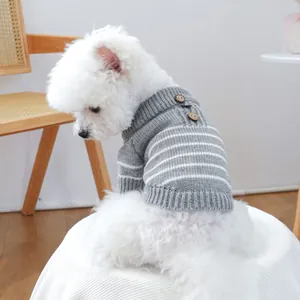 Close-up of grey pet knit sweater with white stripes and decorative wooden buttons