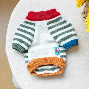 Detail of colorful pet sweater showing ribbed cuffs and soft knit texture on plush background