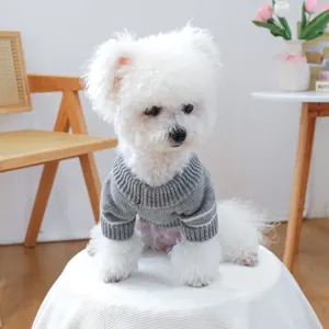 Detail of grey knitted pet sweater with white stripe sleeves on a small dog