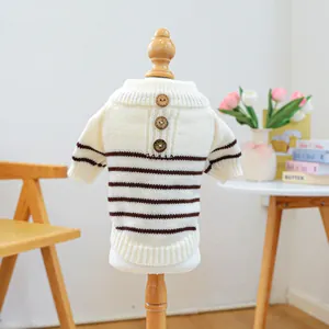 Close-up of pet knit sweater with brown stripes, wooden buttons, and soft texture