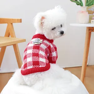 Detail of red and white checkered pet sweater with 3D flower and ribbed neck trim