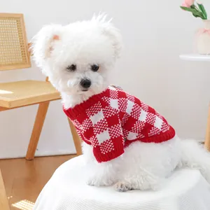 Close-up of a dog wearing a red and white checkered knit sweater with ribbed edges