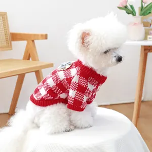 Detail of pet knit sweater showing red checkered pattern and floral ornament on back