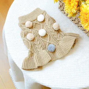Detail of khaki cable knit pet sweater featuring 3D plush balls and ruffled hem