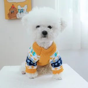 Detail of pet knit sweater showing high-neck yellow ribbed collar and blue geometric patterns