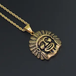 Detailed close-up of golden Indian chief pendant with intricate feathers on a thick rope chain