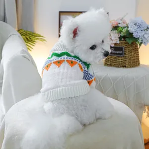 Detailed knit texture of a dog sweater with geometric orange and blue patterns